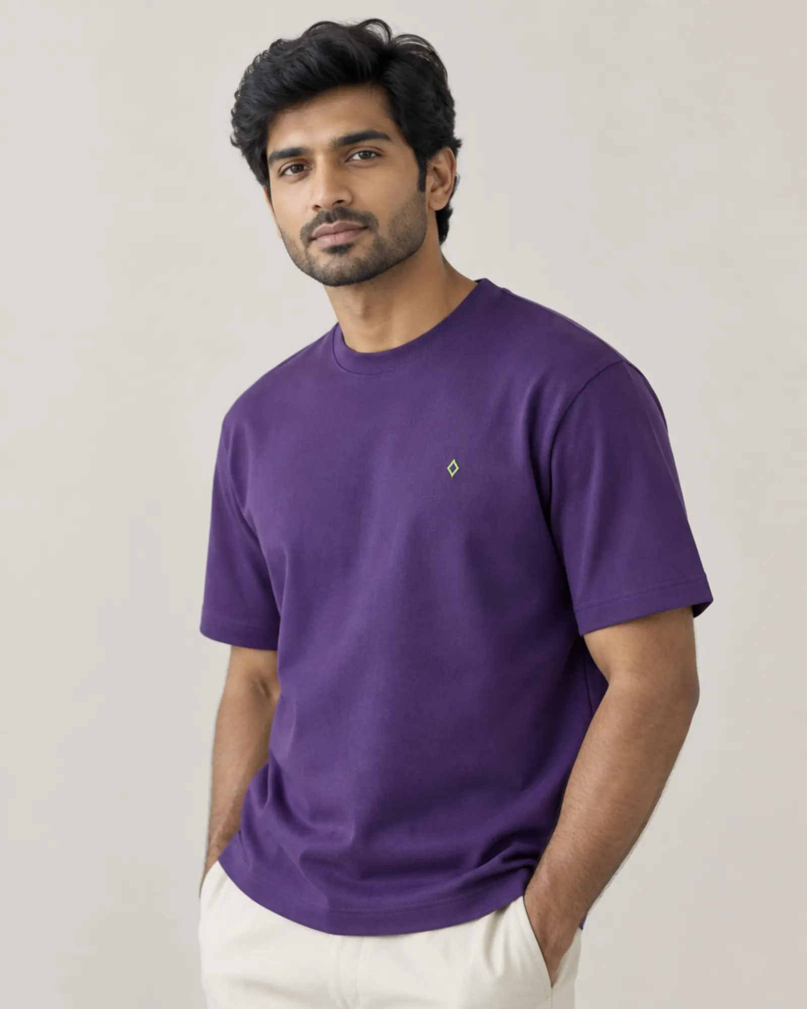 A man in a violet Fleeke t-shirt